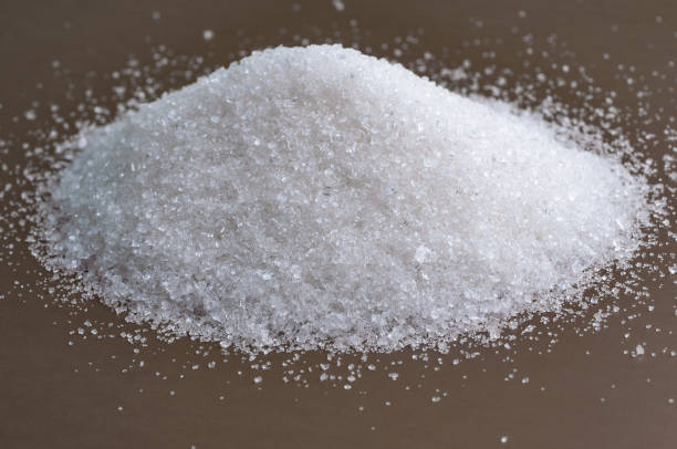 istock Heap of white sugar on a gray background 821661998