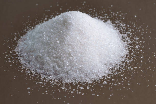 istock Heap of granulated white sugar on gray background 821662084