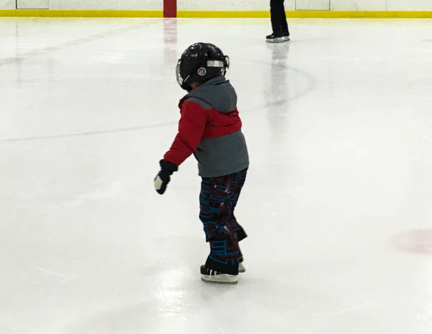 istock Child skating in indoor ice rink 821662530