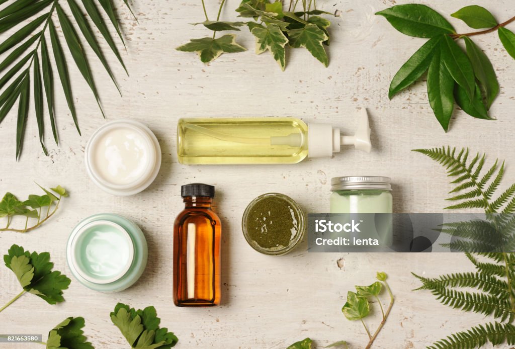 green cosmetic arrangement arrangement of natural herbal cosmetics on wooden background Merchandise Stock Photo