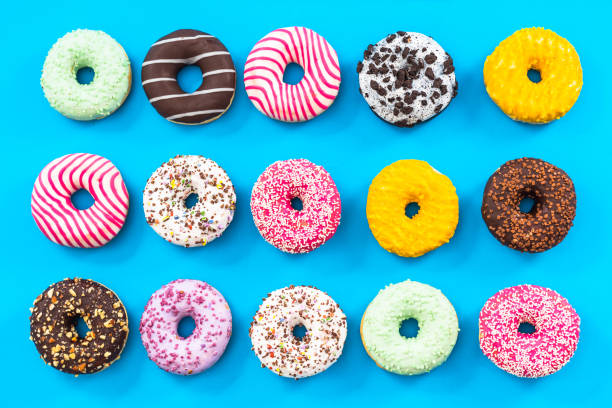 istock Colorful donuts border background, top view flat lay 821676178