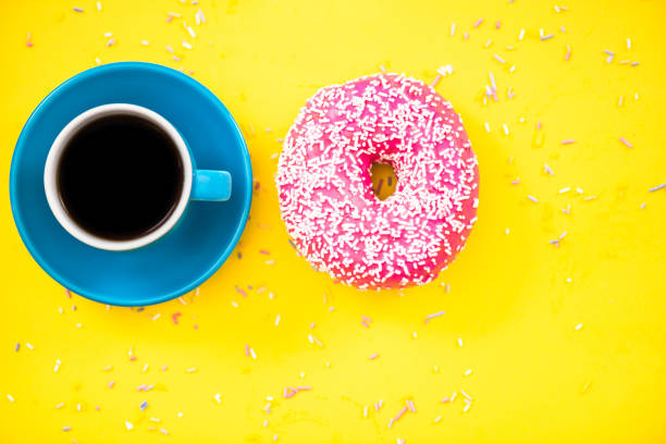 istock Colorful glazed donut and cup of coffee 821676354
