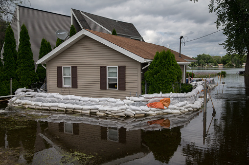 Sandbags circle a home surrounded by water due to flooding on the Fox River in McHenry County, Illinois