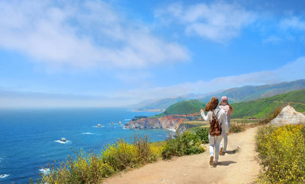 istock People hiking in the mountains along the shore. 821681710