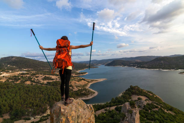 istock Successful woman backpacker enjoy the view at mountain peak 821681874