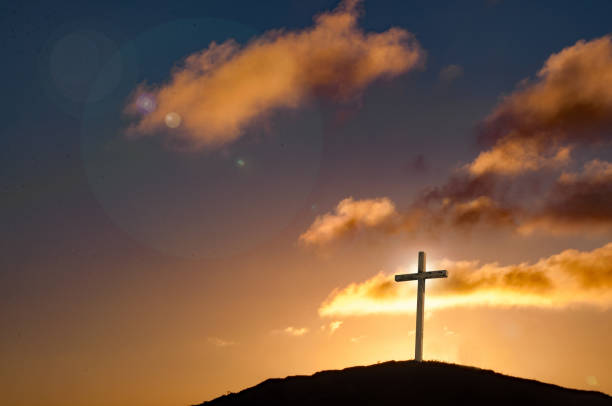 istock Cross on hilltop with light behind the crucifix 821684426