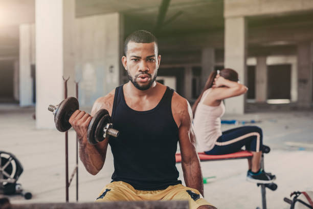 istock Young man lifting dumbbell in a Urban  Gym 821684620