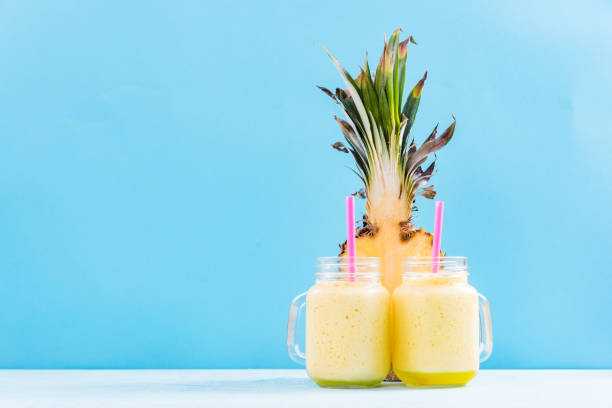 istock Two mason jars with smoothie on vibrant background 821688074