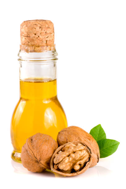 istock Walnut oil with nuts isolated on a white background 821688166