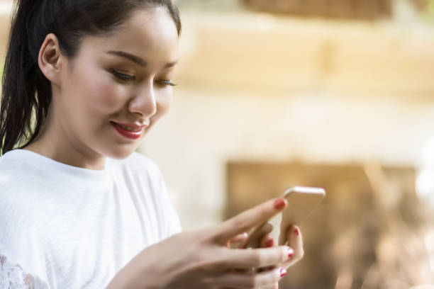 istock Asian woman are using smartphone in park.selective focus 821688542