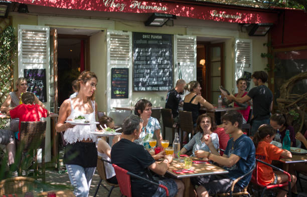 Paris, France - August 12, 2015: Waitress serving food in in a Cafe at Place Saint-Germain-des-Prés.