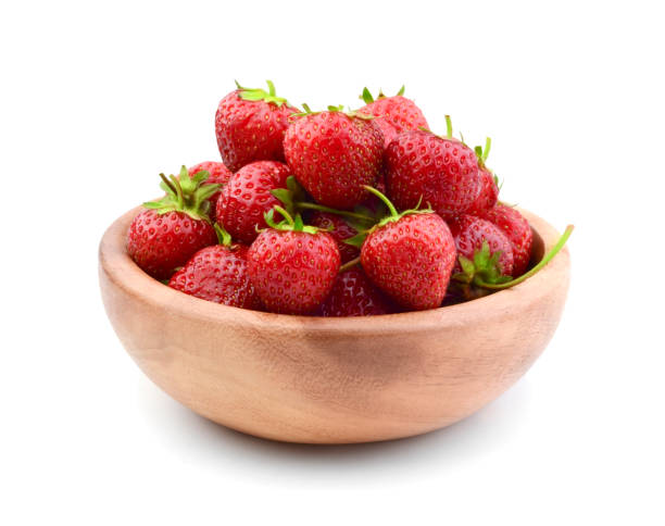 istock Strawberries in a wooden bowl isolated 821694436