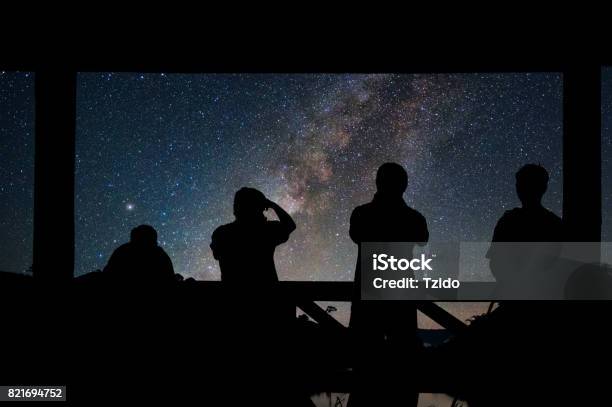 Silhouette Of A Photographers Group Who Shoots The Landscape Of Milky Way Over Reservoir With Mountain And Deep Forest At Night Sky Stock Photo - Download Image Now