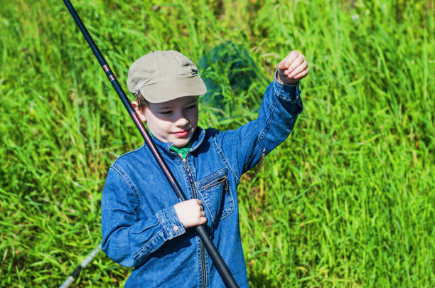istock boy fishing in the summer 821694770