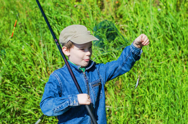 istock boy fishing in the summer 821694776