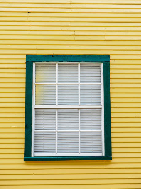 istock Green Framed Window on a Yellow Building 821703150