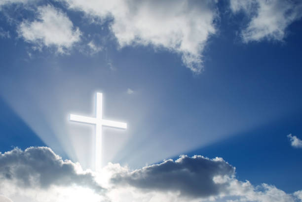 istock Christian cross over beautiful sunny sky 821709584