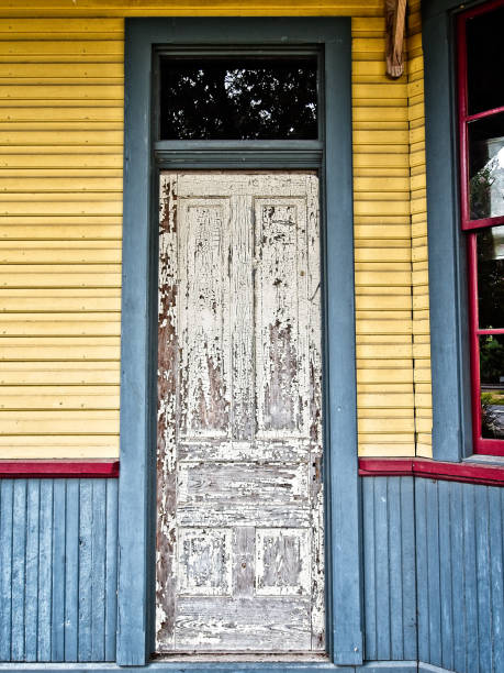istock White Peeling Door with Blue & Yellow Wall 821711932