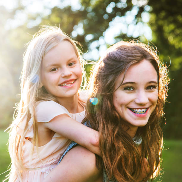 istock Sister Togetherness Outdoors Piggyback Concept 821712198