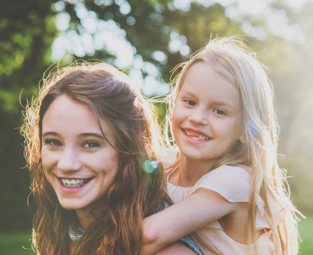 istock Sister Togetherness Outdoors Piggyback Concept 821712206