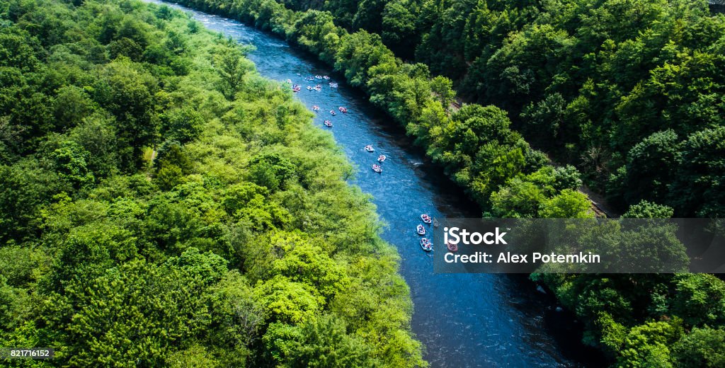 Rafting at the Lehigh River near by Jim Thorp (Mauch Chunk), Carbon County, Poconos region, Pennsylvania Rafting at the Lehigh River near by Jim Thorp (Mauch Chunk), Carbon County, Poconos region, Pennsylvania. The sunny summer day. Aerial photo. Pocono Mountains Region Stock Photo
