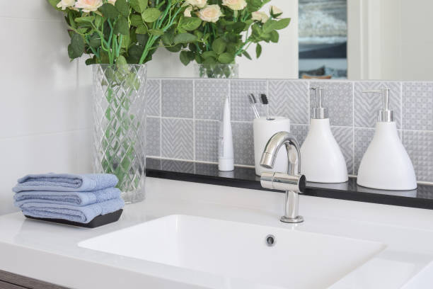 istock washbasin with faucet and liquid soap bottle at home 821716196