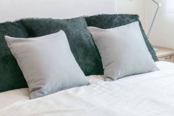 istock modern bedroom interior with grey pillows on white bed 821716370