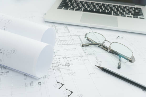 istock black pencil and computer laptop on architectural drawing paper for construction 821716498