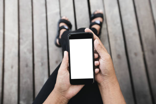 istock woman sitting and using phone outdoor lifestyle 821716600