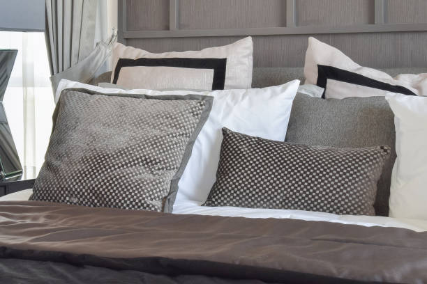 istock stylish bedroom interior design with black patterned pillows on bed and decorative table lamp. 821718638