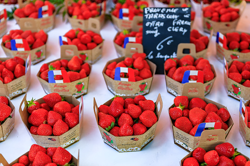 Nice, France - May 26, 2017: Ripe red strawberries at a local outdoor farmers market in Nice, France