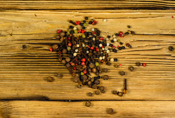 istock Different pepper spices on wooden table. Top view 821720082