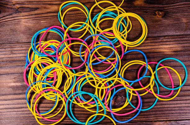 istock Multicolored rubber bands on wooden table. Top view 821722892