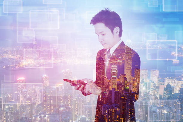istock double exposure of business man using smart phone with city background 821723740