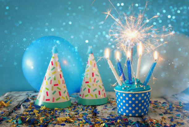 istock Birthday concept with cupcake and candles on wooden table 821723928