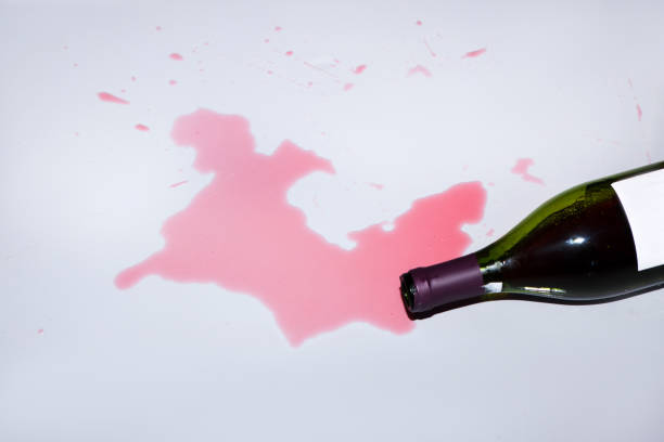 istock A bottle of red wine, knocked over on floor 821727366