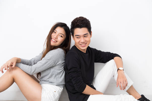 istock Young Asian Couple sitting back to back 821727752