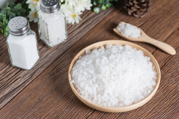 istock Sea salt in wood plate. 821728038