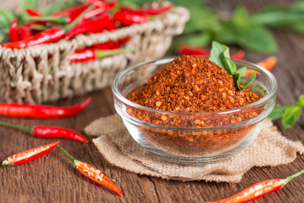 istock Chili powder in spoon and red chili pepper. 821730662