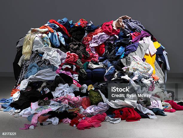 Sofa Buried Under Piles Of Clothes Stock Photo - Download Image Now - Clothing, Stack, Excess