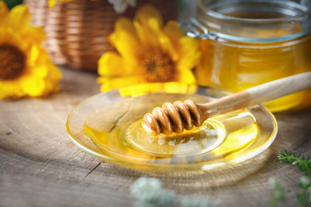 istock Fresh flower honey on a wooden table. Selective focus 821738108