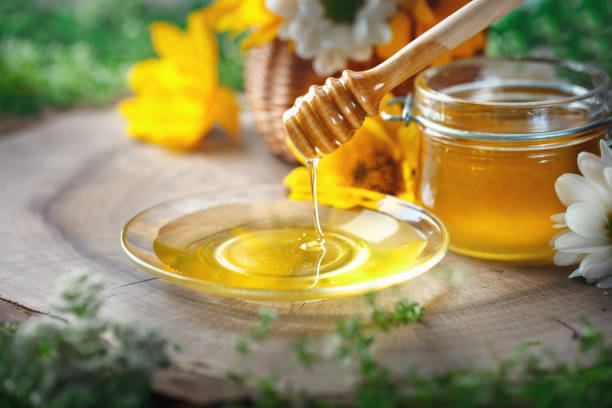 istock Fresh flower honey on a wooden table. Selective focus 821738136