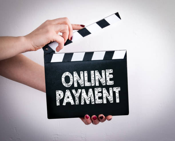 istock Online Payment. Female hands holding movie clapper 821738256