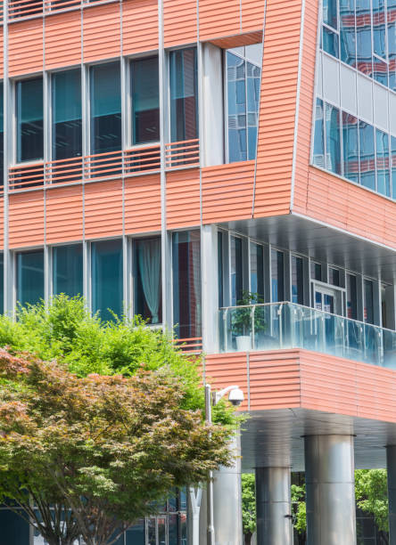 istock detail shot of modern architecture facade with green tree 821738376