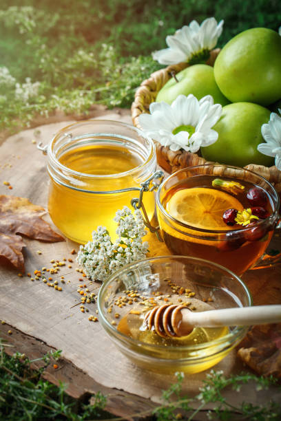istock Fresh honey, pollen and ripe apples on a wooden table. Selective focus 821738506