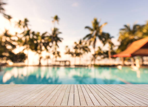 istock Wooden terrace beside tropical swimming pool 821738564