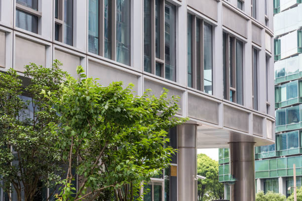 istock detail shot of modern architecture facade with green tree 821738778