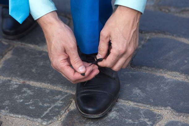 istock A man ties up his shoelaces 821742386
