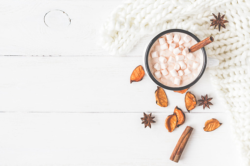 Autumn composition. Hot chocolate, knitted blanket, autumn leaves. Flat lay, top view, close up