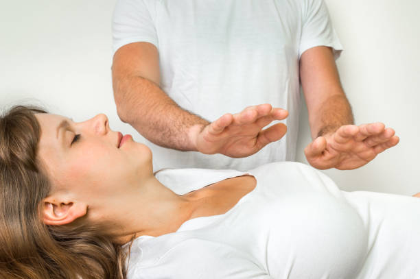 istock Young woman having reiki healing treatment 821746164